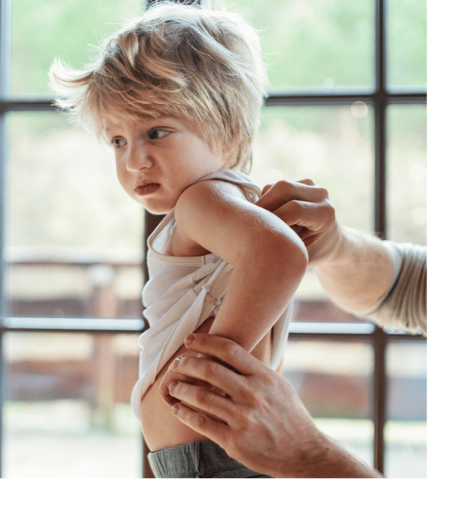 a little girl standing in front of a window